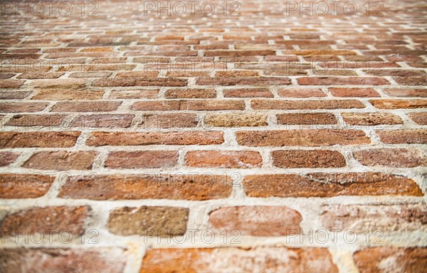 Old red brick wall texture. Selective focus in the center of the photo