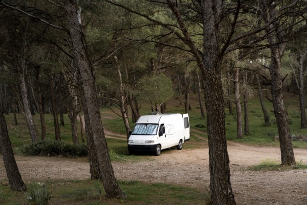 Camper van on a wild spot on a forest