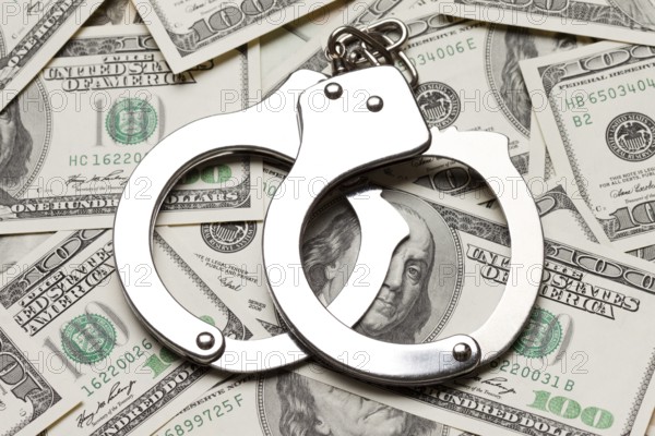 Crime law handcuffs arrests paper dollars currency