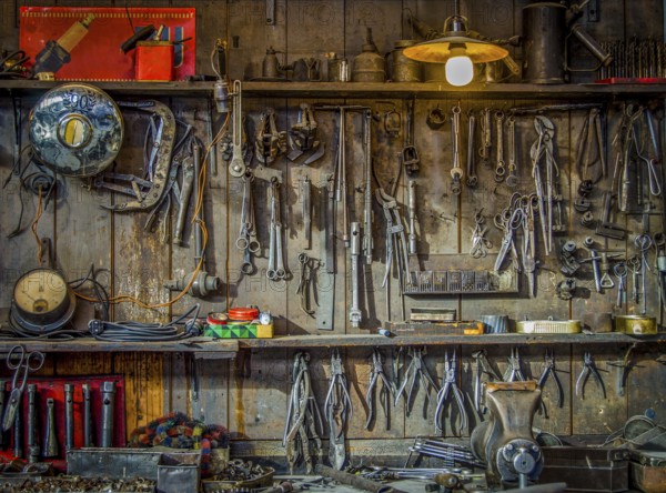 Vintage Tools Hanging On A Wall In A Tool Shed Or Workshop