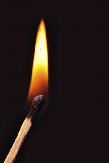 Match burns in a black background