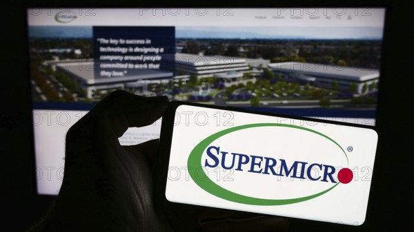 Stuttgart, Germany, 02-13-2024: Person holding smartphone with logo of US company Super Micro