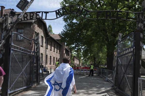 Jude wiith the Israel flag in the German nazi concentration camp Auschwitz Birkenau. Writing over
