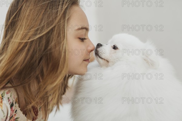 Girl dog touching noses