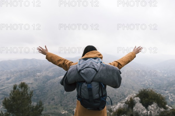 Female backpacker standing top mountain loving nature