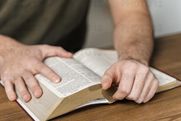 Man reading from bible table