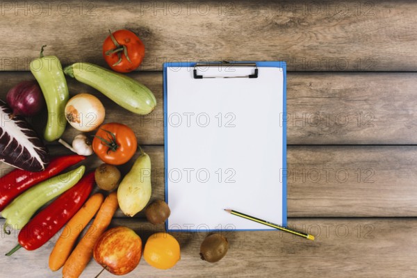 Fruits vegetables near clipboard