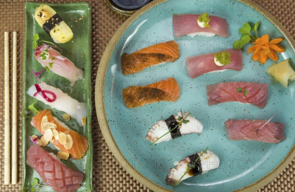 Platter with different types of nigirizushi, nigiri with different fish and one decorated with a