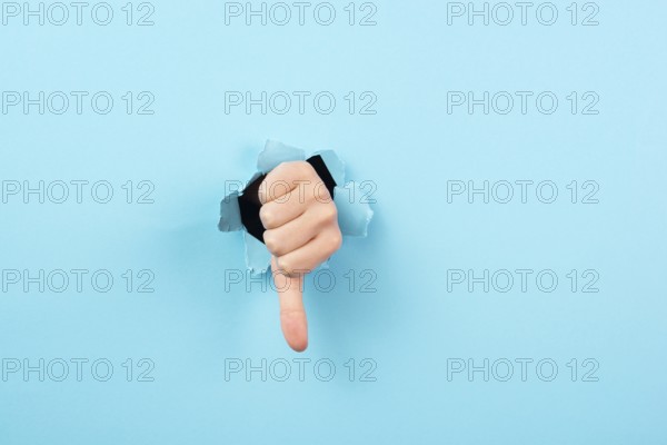 Thumb down, negative hand gesture, dislike or disagree, expression of disappointment, blue torn