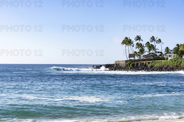 View of a paradisiacal beach in Oahu, Hawaii. Waimea Beach ia a popular snorkeling spot