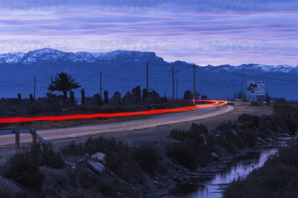 Country road in the Ebro Delta, red tail lights of a car, Catalonia, Spain, Europe