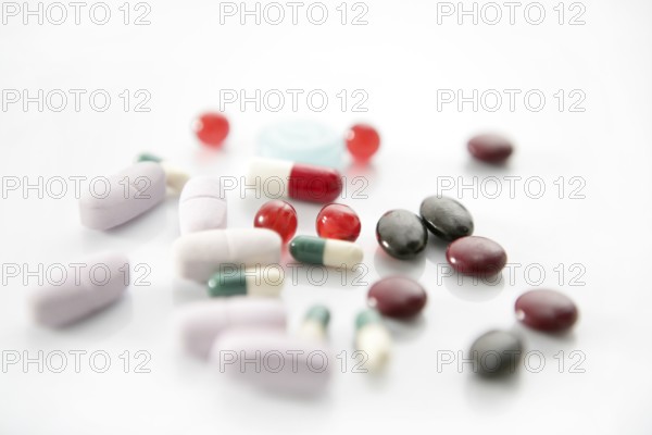 Pills over white, health or suicide, metaphor