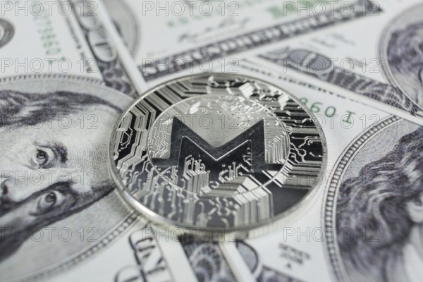 Silver Monero macro photo on hundred dollars bills