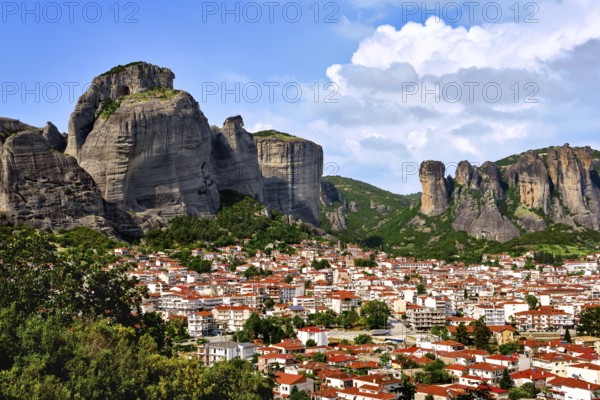View of Kalampaka and Kastraki villages at foot of Meteora cliffs and pillars on sunny spring day.