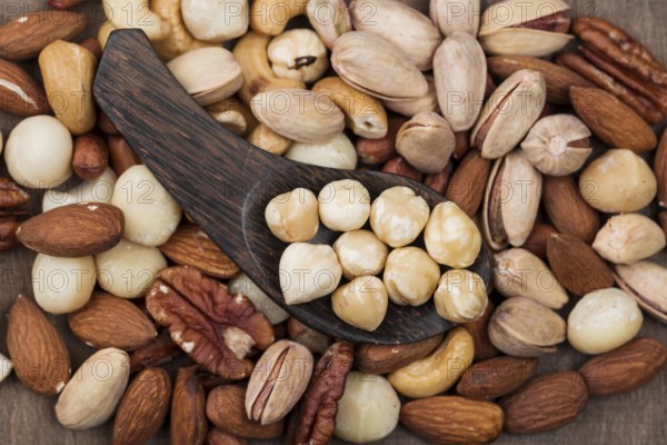 Various organic nuts snack spoon background