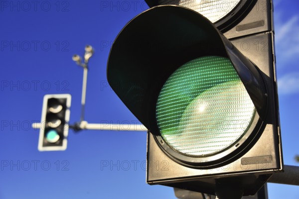 Traffic lights over blue sky. Green light