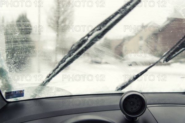 Interior view of a smudged windscreen of a car with windscreen wipers