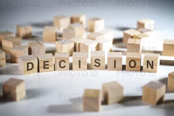 Word DECISION written on wooden cubes among a lot of others, concept to make the right choice in