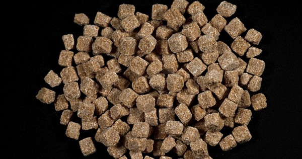 Cane Sugar falling against Black Background