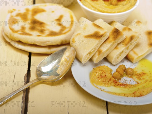 Traditional chickpeas Hummus with pita bread and paprika on top