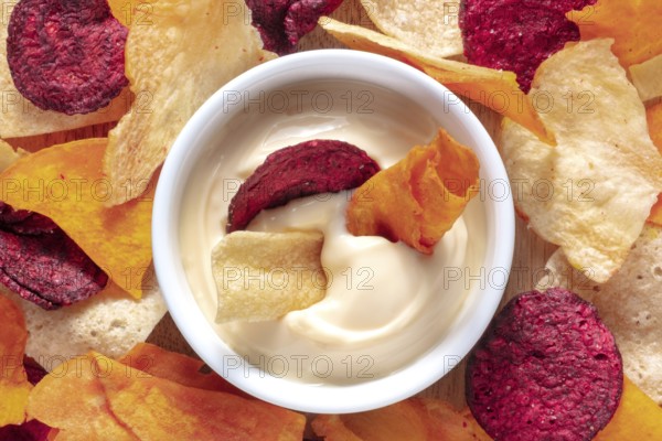Vegetable chips with a dip close-up shot, top view