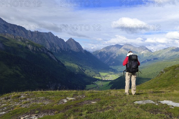 Hiker looking from the Pfitscherjoch into the Pfitschtal, Pfitsch, South Tyrol, Italy, Europe