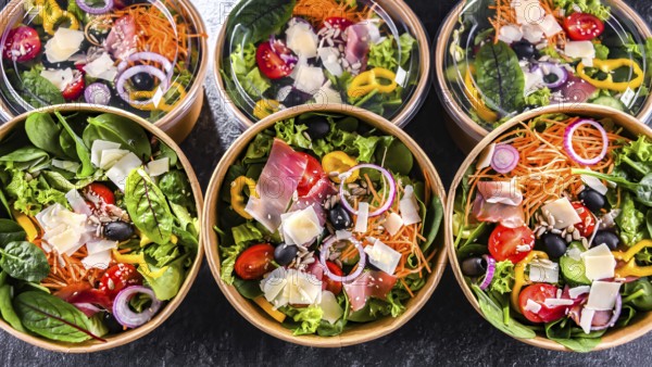 Round paper boxes with pre-packaged vegetable salads ready for sale