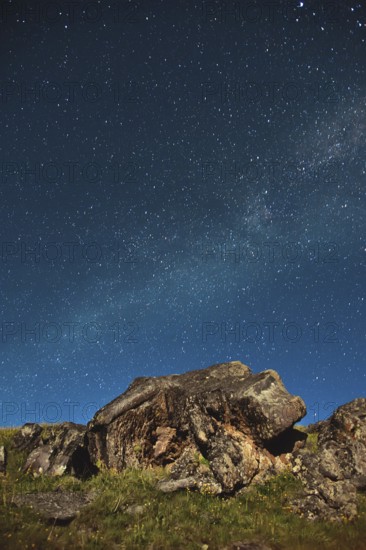 A large rock in the Caucasus against the Milky Way