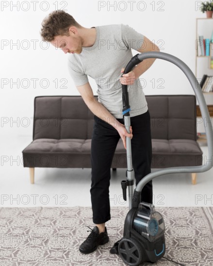 Male with vacuum cleaning