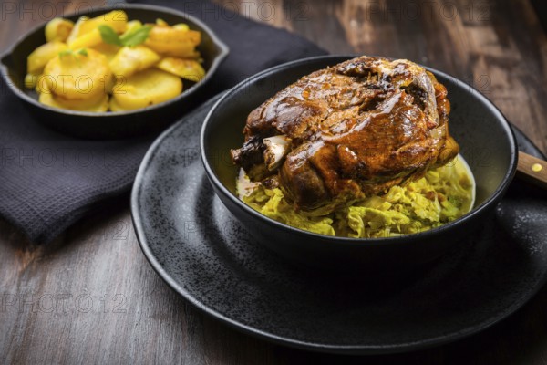 Roaster Pork Knuckle with savoy cabbage and baked potatoes - Traditional German cuisine, Eisbein,