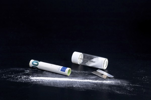 Cocaine Line and Razor Blade on a Black Background
