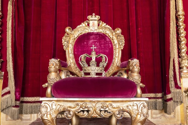 Genoa, Italy, 06 August 2023: Royal Palace, throne room interior, gold and red velvet, Europe
