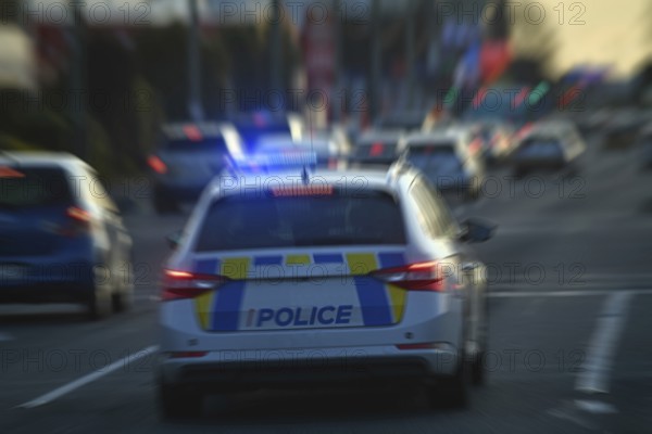 CHRISTCHURCH, NEW ZEALAND, AUGUST 30, 2022: A police car weaves through peak hour traffic on