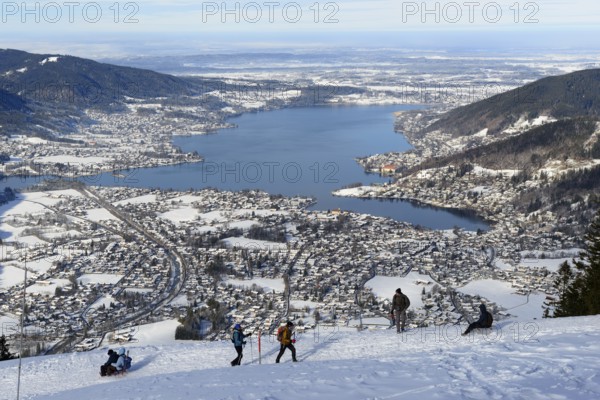 Hikers climbing the Wallberg, sledgers tobogganing down, behind Tegernsee, winter, snow,