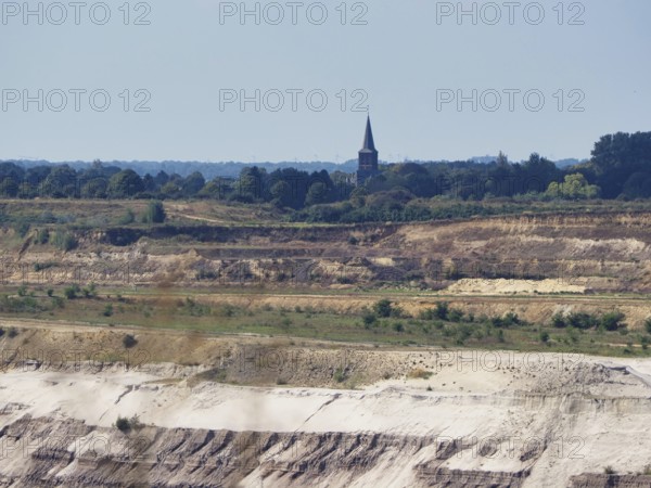 A church tower right on the edge of the Garzweiler open-cast lignite mine, Rhenish lignite mining
