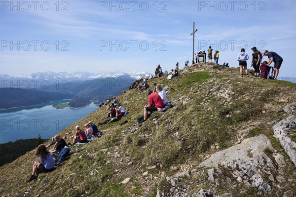 Many hikers take a break at the summit of the Jochberg, Walchensee, Upper Bavaria, Bavaria,