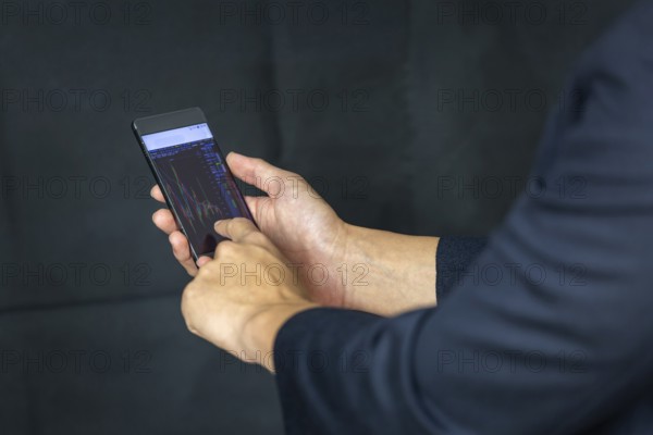 Stock Trader Looking At Stock Chart on Screen