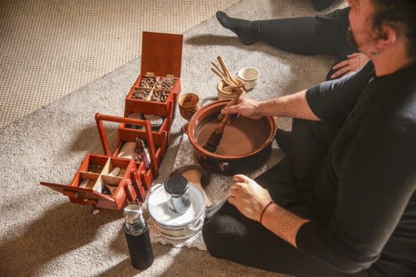 A shaman prepares ceremonial cocoa for healing and spiritual connection