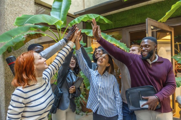 Diverse happy coworkers with hand put together for the unit of teamwork in a nice patio of a