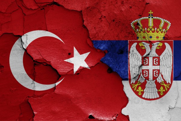 Flags of Turkey and Serbia painted on cracked wall