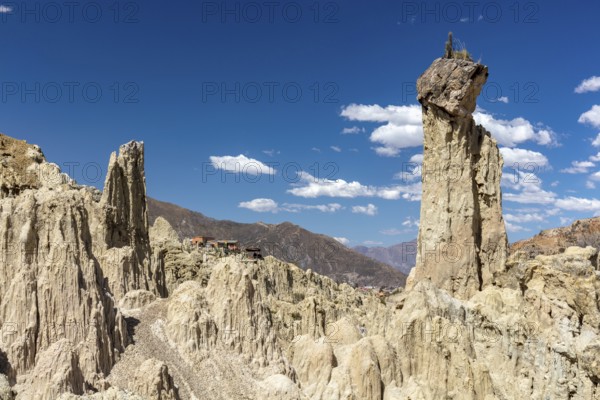 Earth pyramids with rocks on top, called Demoiselles Coiffées, precariously balanced rocks in Valle