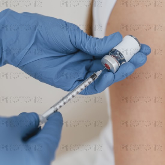 Doctor with gloves preparing syringe with vaccine