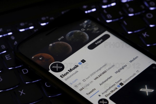 Symbolic image social media, close-up of a smartphone on illuminated computer keyboard with X logo
