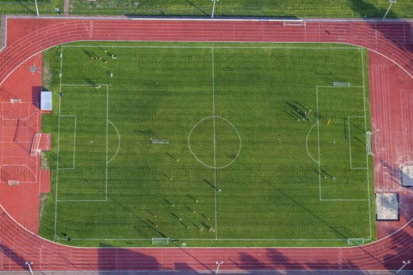 Aerial view at a soccer field with soccer players in Germany, Rhineland Palatinate near Bad