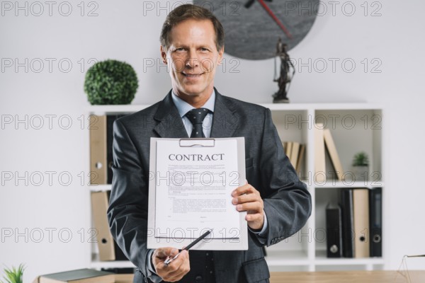 Mature lawyer pointing signature place contract document with pen