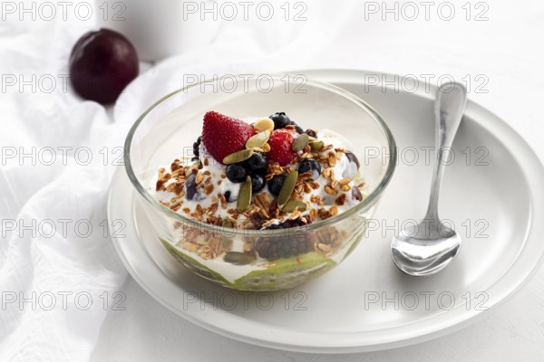 High angle yogurt with cereals fruits