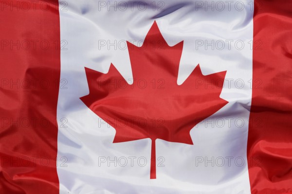 Close-up of the national flag of Canada, fluttering in the wind with folds, wave pattern