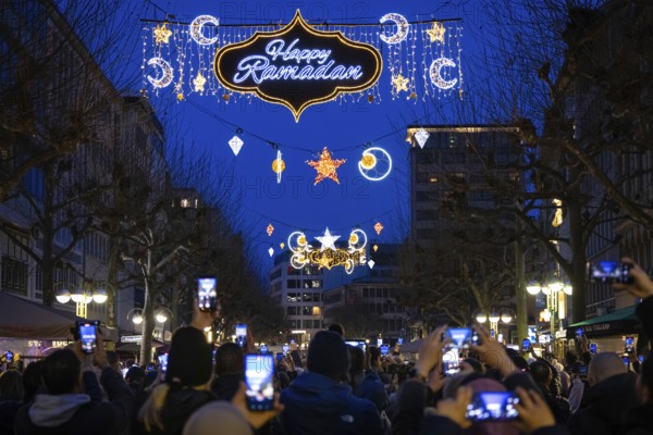The illuminated lettering Happy Ramadan shines on the evening of 10 March 2024 as part of a light