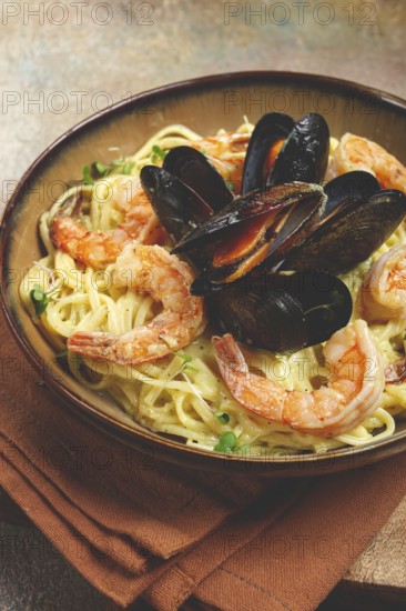 Spaghetti carbonara, with shrimp and mussels, seafood in creamy garlic sauce, homemade, no people
