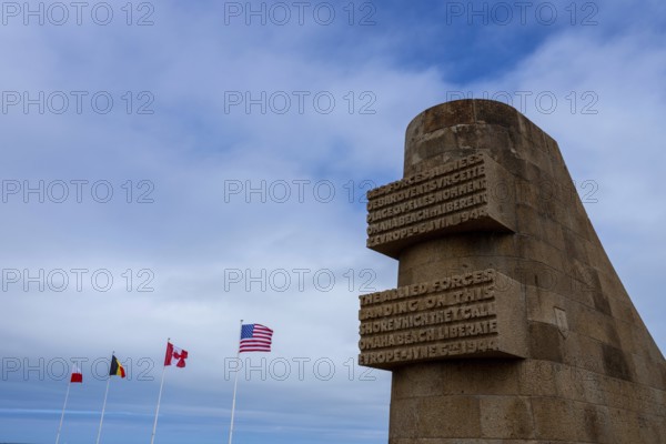 Walking the sands of Omaha Beach, the echoes of D-Day's fierce battle linger in the air. Waves